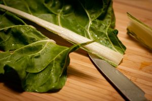 Bo La Lot Vegan recipe cutting Swiss chard leaves
