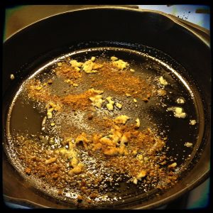 Sauteeing the Curry powder and garlic for curried greens